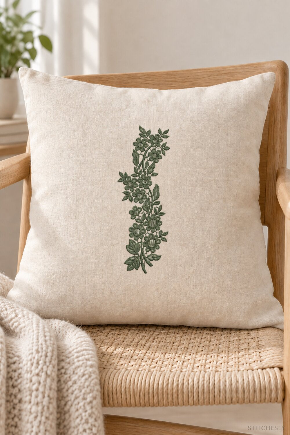 Generated usage mockup of a linen cushion with the lattice blossom vine machine embroidery motif in one deep muted eucalyptus green thread color.