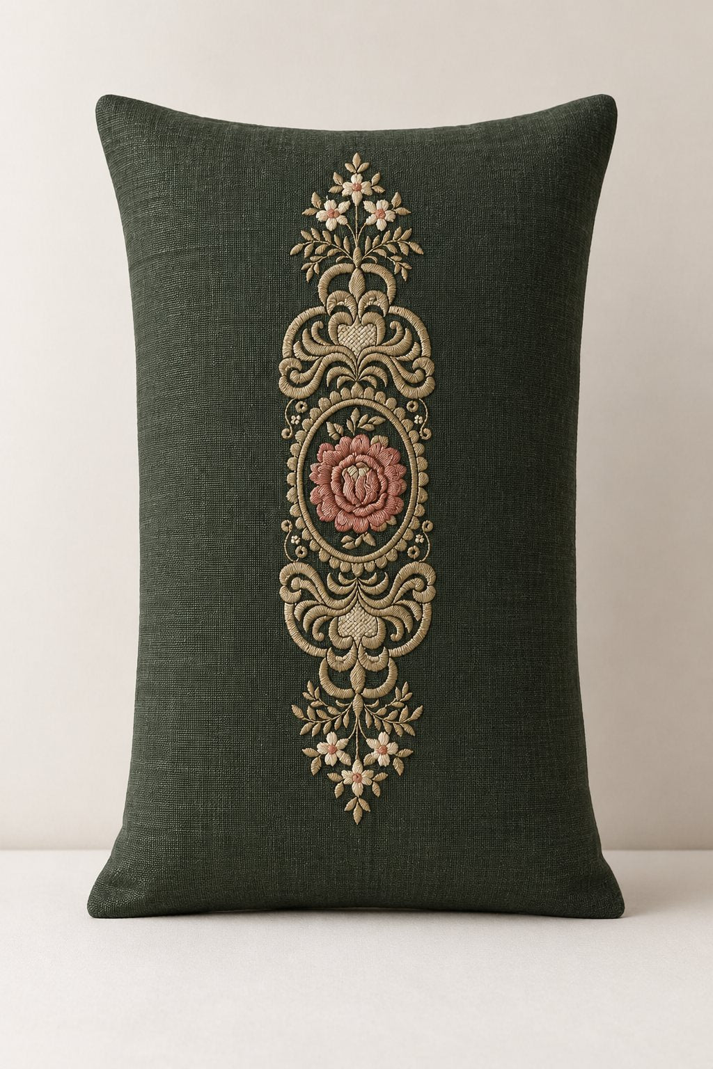 Photorealistic rose oval medallion machine embroidery in forest green, muted terracotta and antique ivory thread on a forest linen lumbar cushion, shown as one fabric-stitched motif