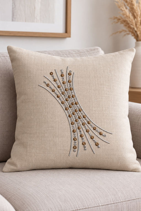 Photorealistic sweeping seed dot branch machine embroidery in soft graphite and warm bronze thread on a large linen cushion, shown as one fabric-stitched motif