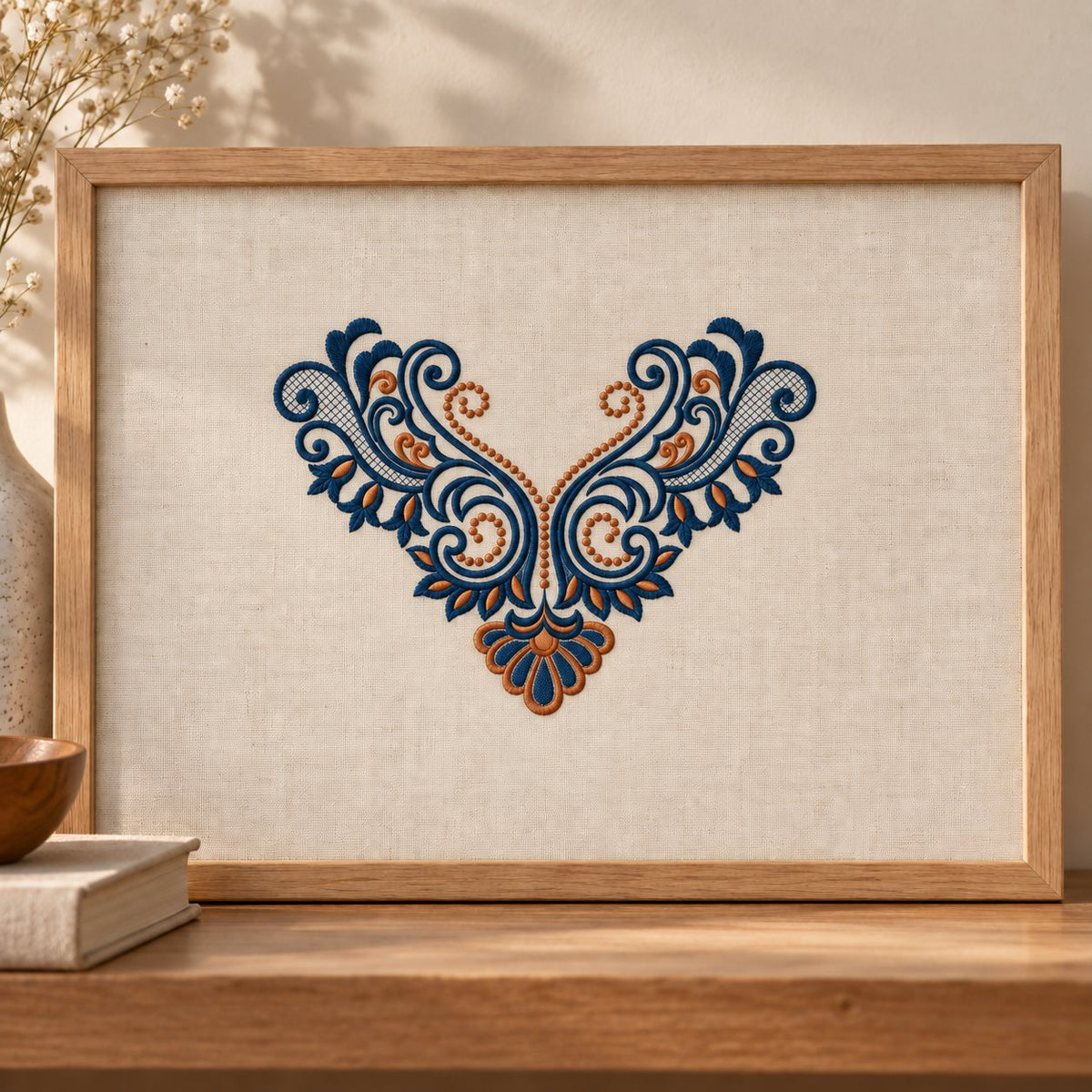 Oak-framed linen panel displaying an ink-blue acanthus neckline motif with copper dotted curls and a lower fan.