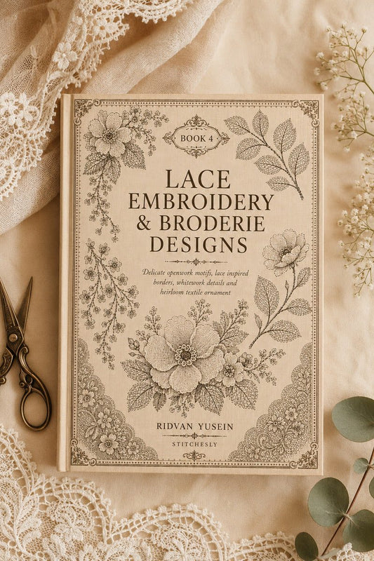 Lace Embroidery and Broderie Designs Book Four cover lying on linen beside lace and leafy sprigs.