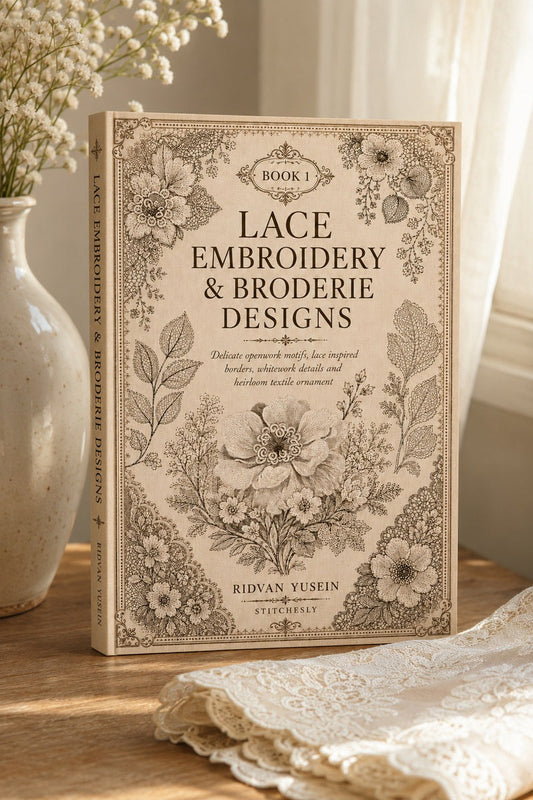 Lace Embroidery and Broderie Designs Book One cover standing beside a vase in soft window light.