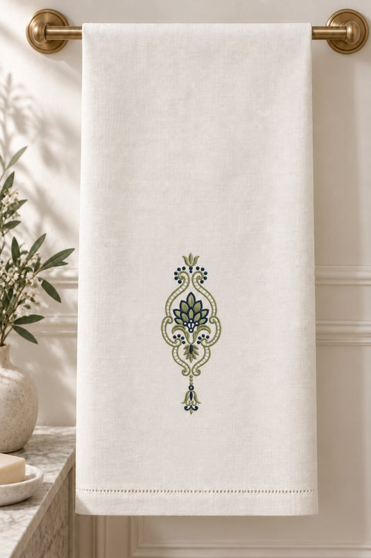 Leaf Fan Scroll Pendant embroidered in smoky sage and ink blue on a linen guest towel, showing the complete two-color motif.