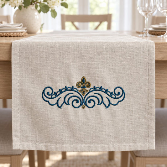 Two-color peacock and antique brass fleur-de-lis scroll machine embroidery on a natural linen table runner