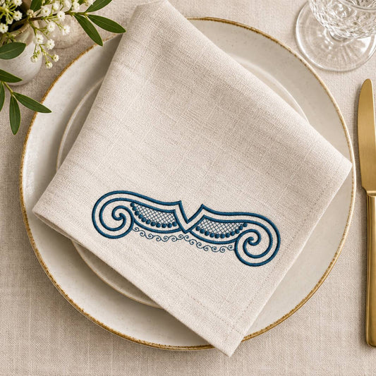 Single-color petrol shell scroll machine embroidery on a natural linen dining napkin