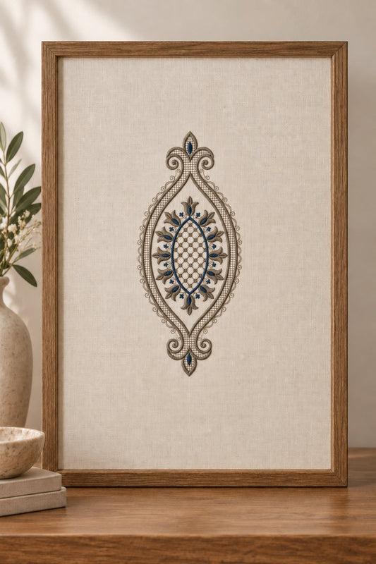 Wooden frame holding ivory linen embroidered with a pewter and midnight blue tulip teardrop medallion.