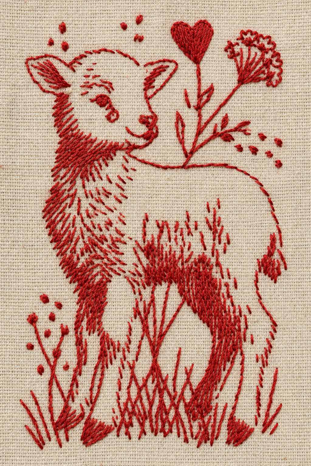 Embroidery visualization of standing lamb with a heart and flower in a single red cotton thread color on oatmeal linen.