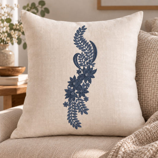 Single-color smoked-indigo botanical paisley machine embroidery on a warm linen cushion