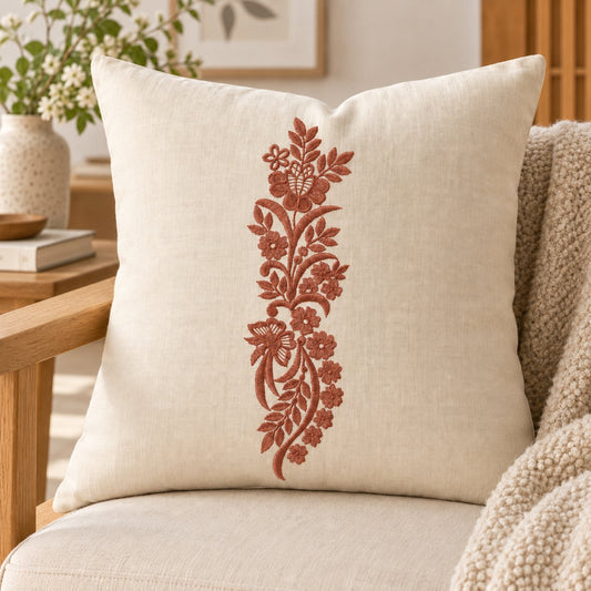 Single-color smoked-terracotta butterfly floral machine embroidery on a linen cushion