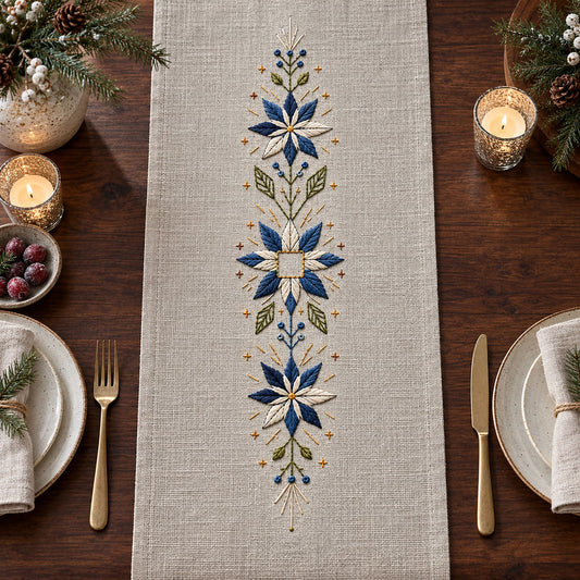 Linen table runner mockup featuring the Snowflower Center Panel hand embroidery design. Blue-white snowflowers form a narrow vertical arrangement around an unfilled square detail.