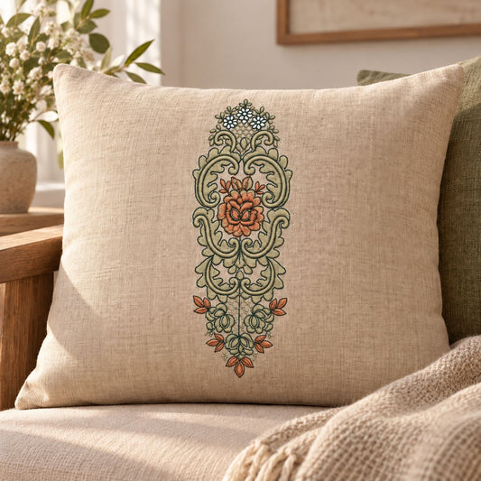 Three-color rose cartouche machine embroidery in blue-green, dusty apricot and lichen-beige on a linen cushion