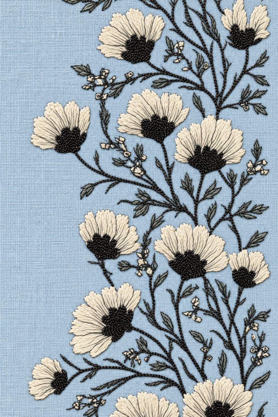 Fine cotton embroidery of dark centered flower branching border on powder blue linen.
