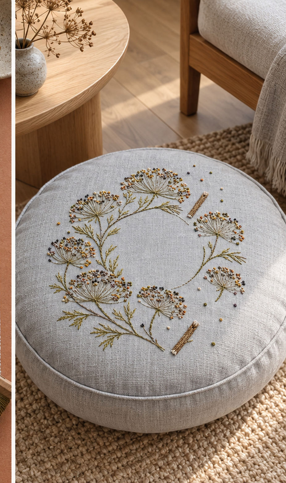 Round linen cushion mockup featuring the Umbel Seed Halo hand embroidery design. Fine umbel stems and dispersed seed points trace an incomplete halo on blue-grey linen.