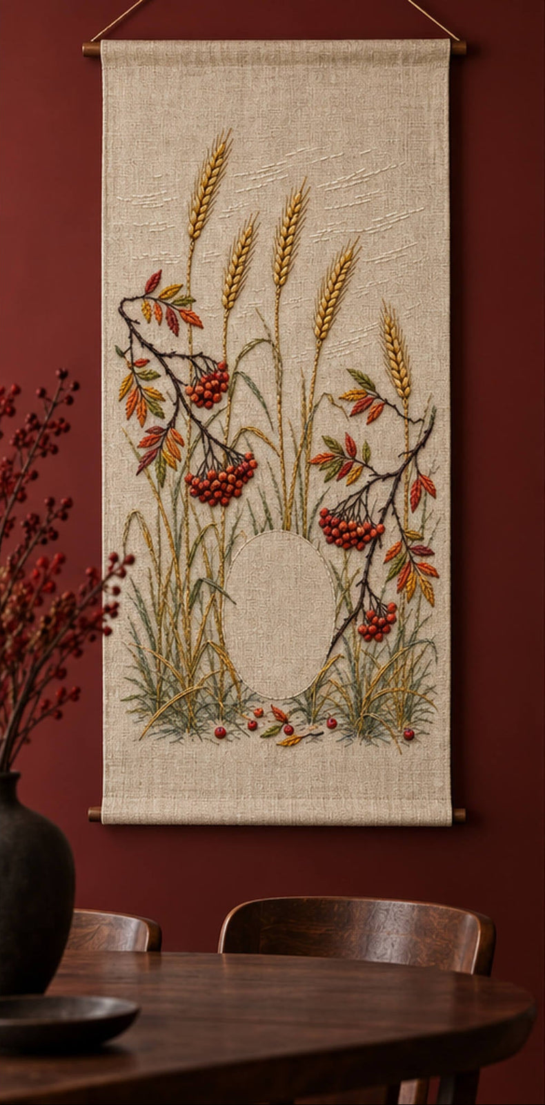 Hanging linen panel mockup featuring the Winter Rye and Rowan Lights hand embroidery design. Tall rye stems and curved rowan branches grow around a clear oval.